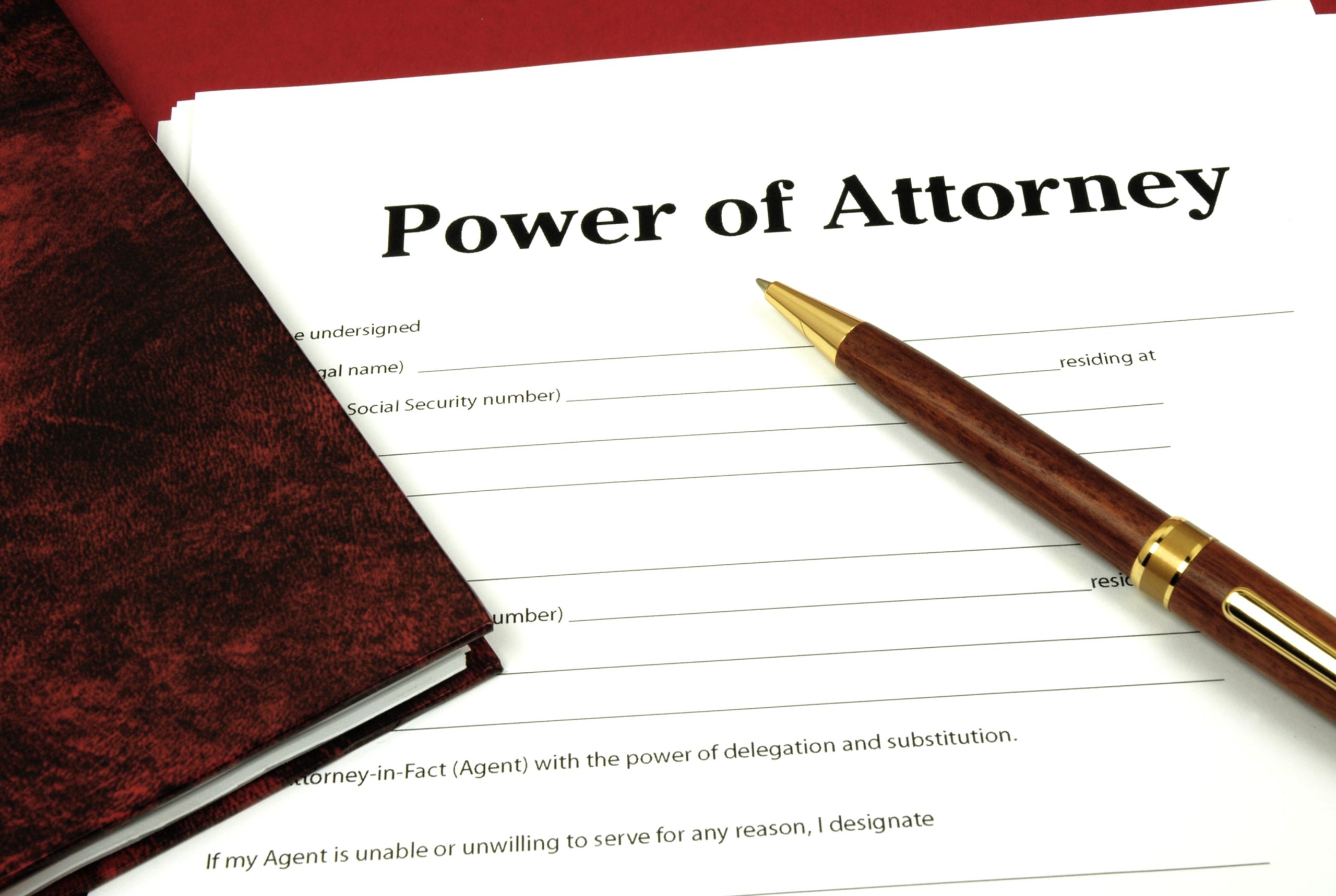 Power of attorney paper with pen and book