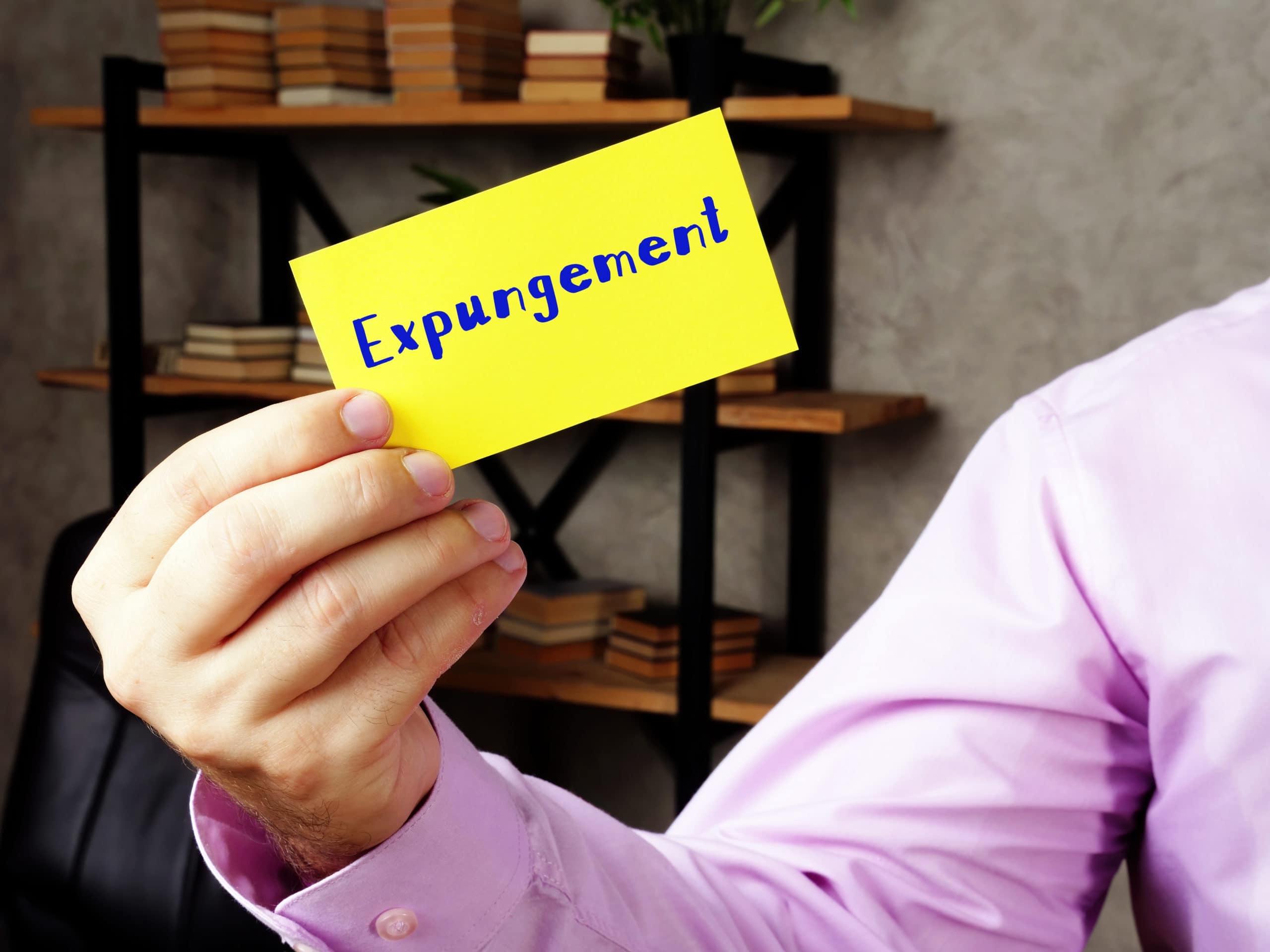 Man Holding Card With Expungement Written On It