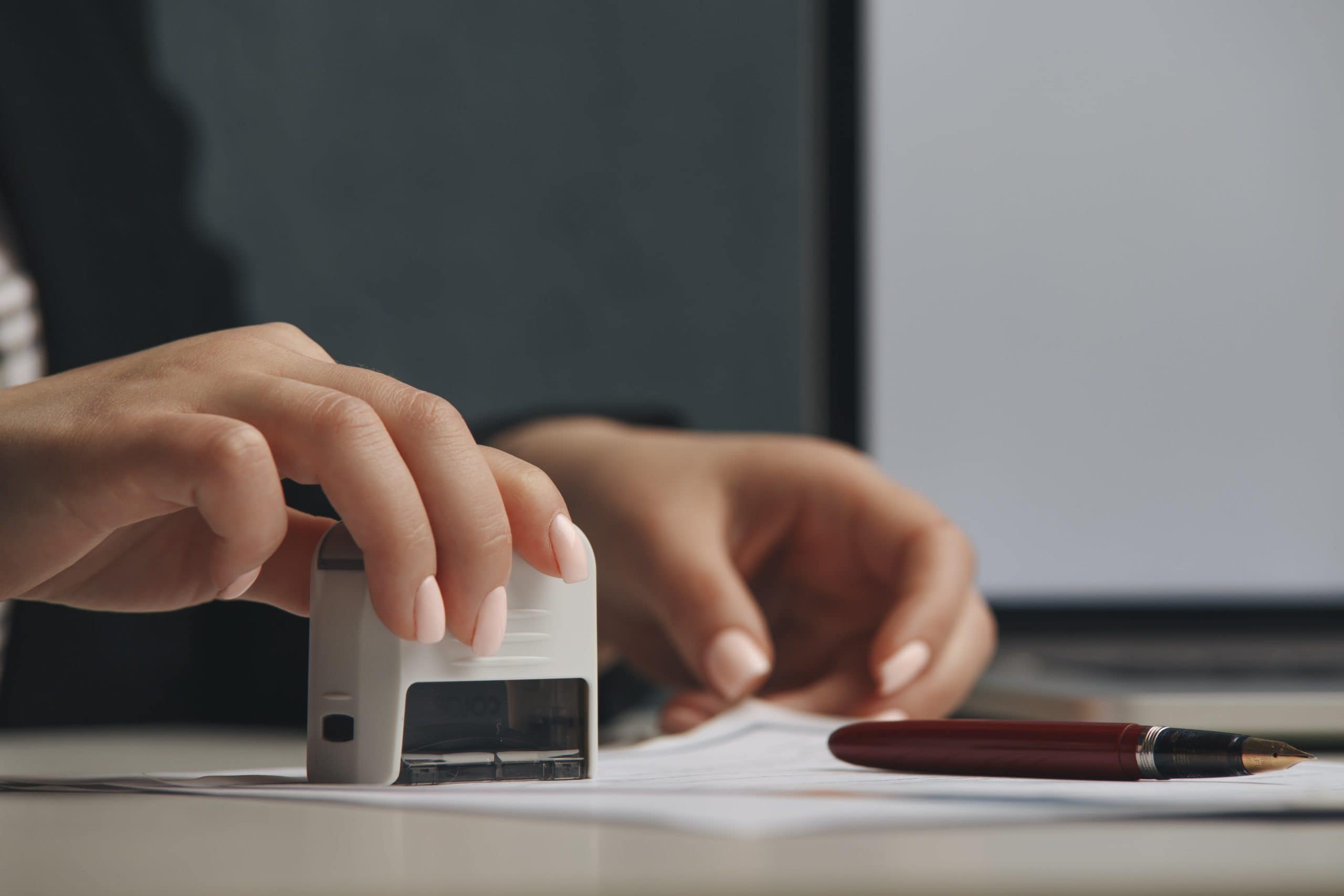 Woman'S Hands Notary Stamping A Legal Document