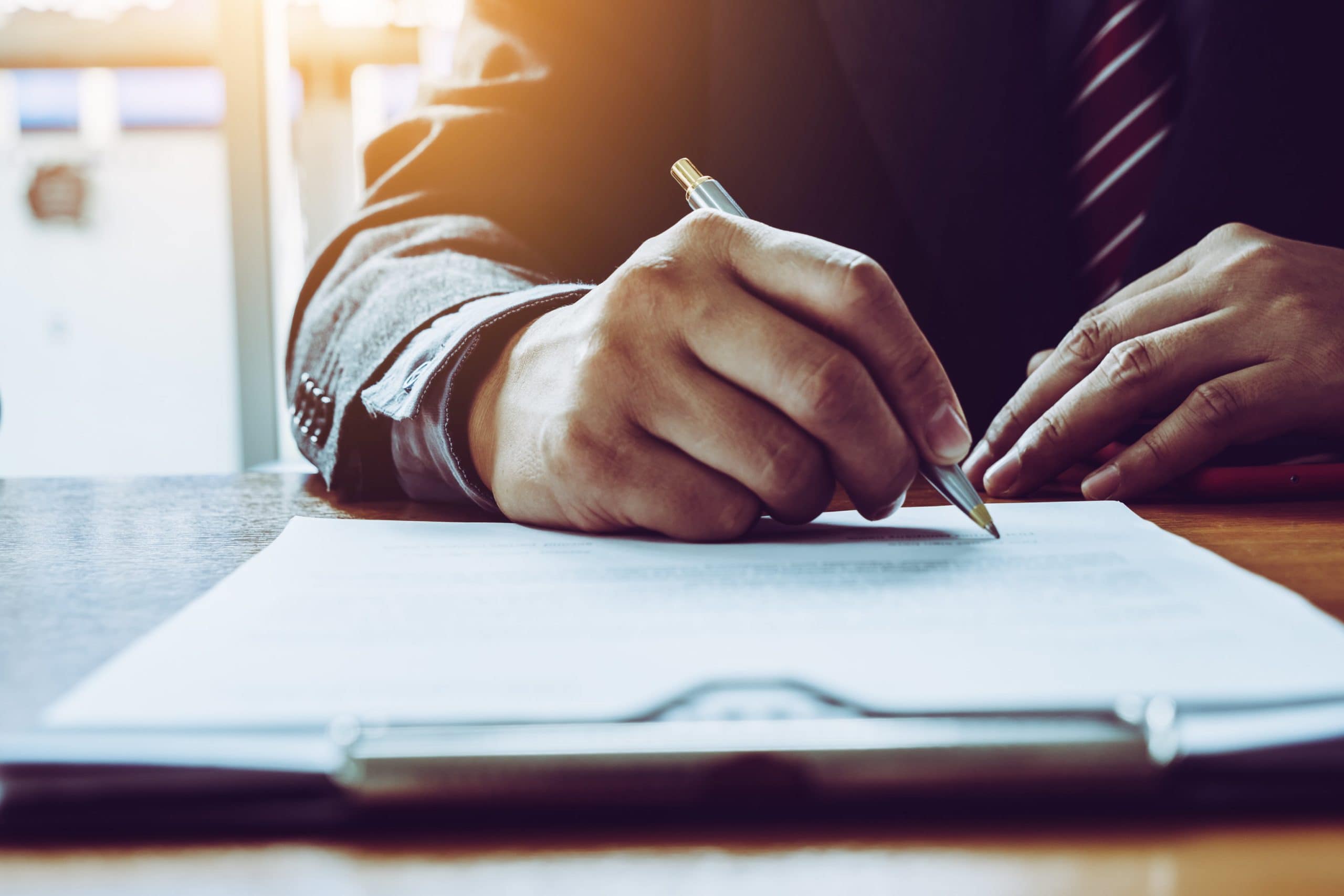 Man Signing Legal Documents Alone