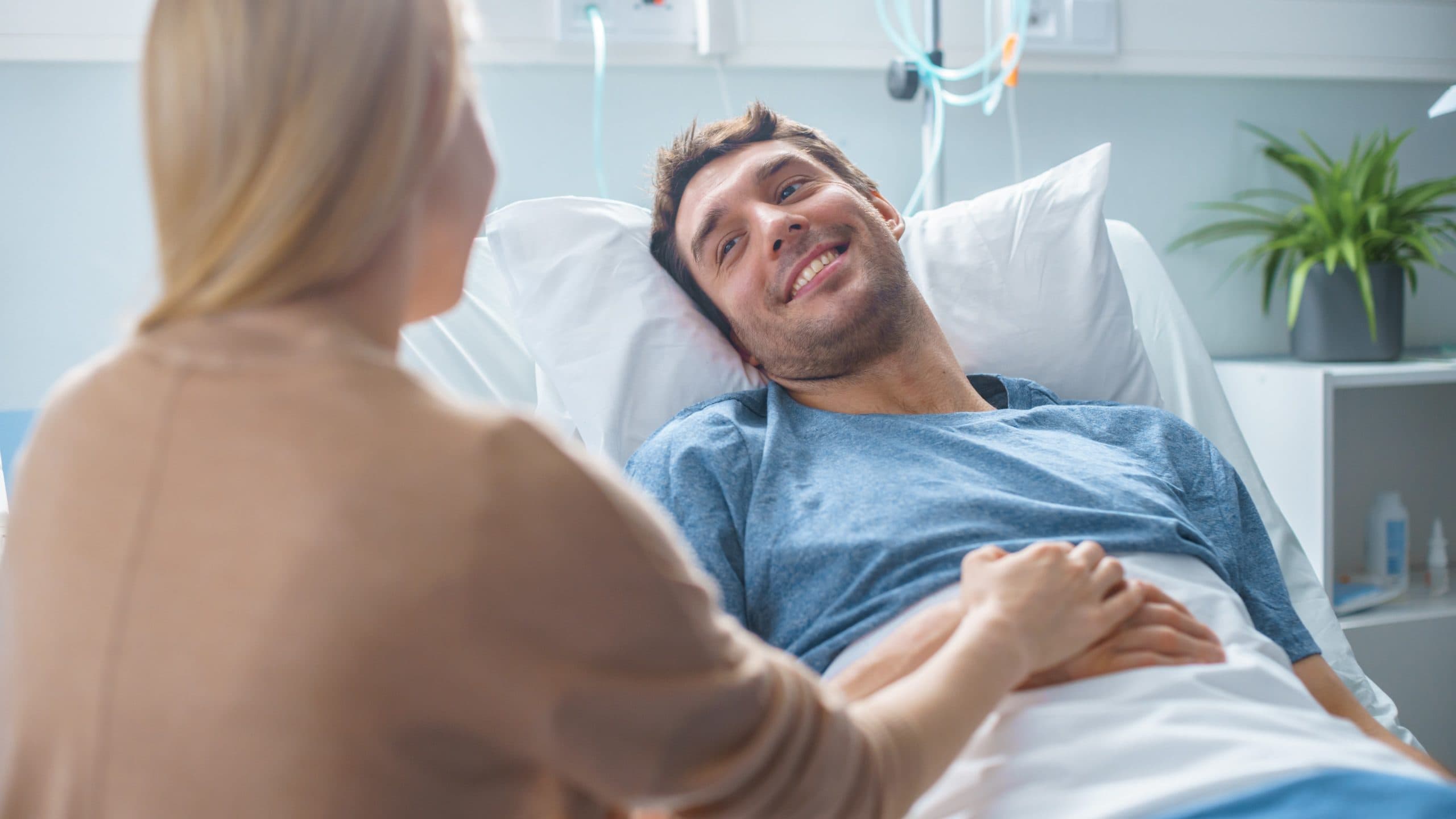 woman visiting man in hospital