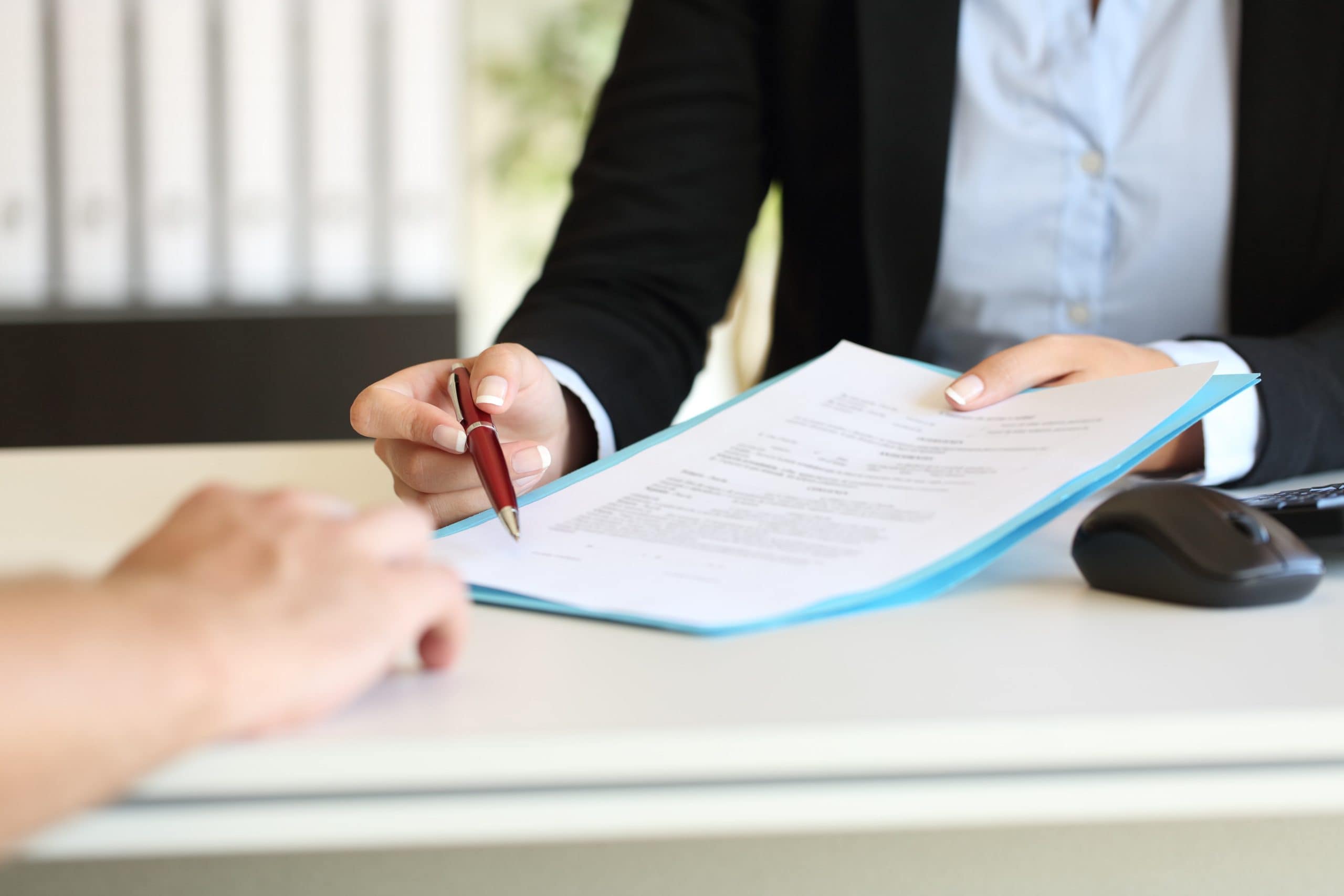 Woman Pointing Out Line On Document